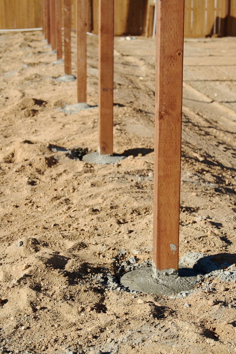 Fence posts set in concrete during installation