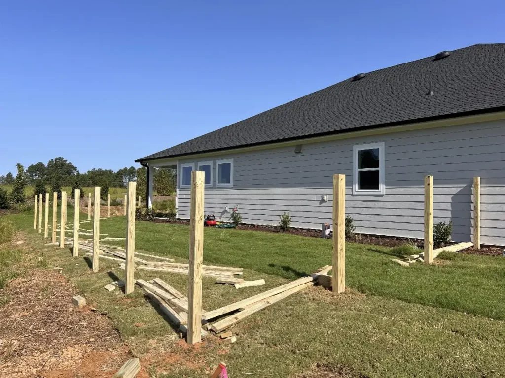 Crew building a wood fence