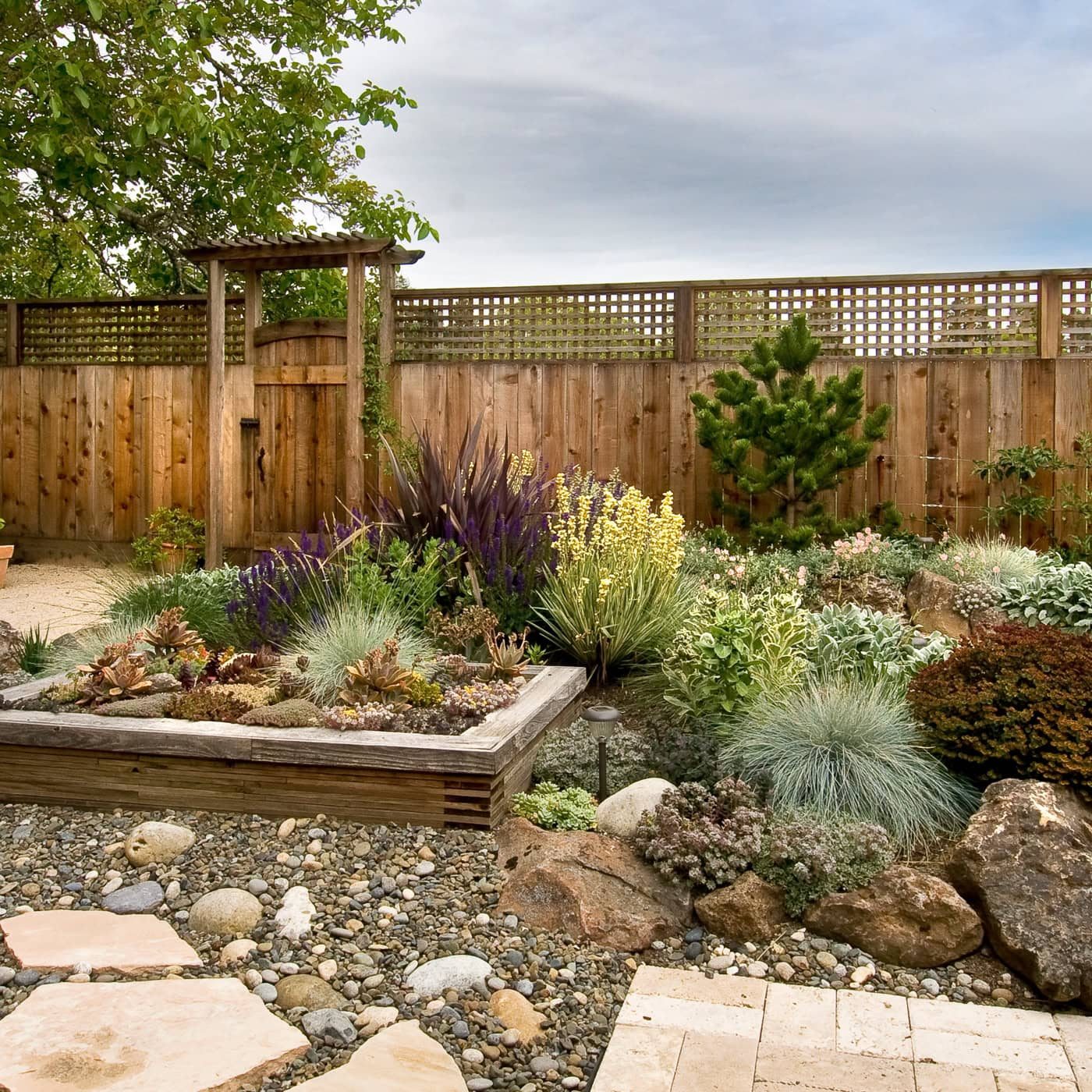 Lattice-top cedar privacy fence with an arbor and gate